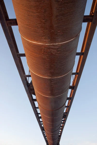 Suspended rusty pipe shot from below — Stock Photo, Image