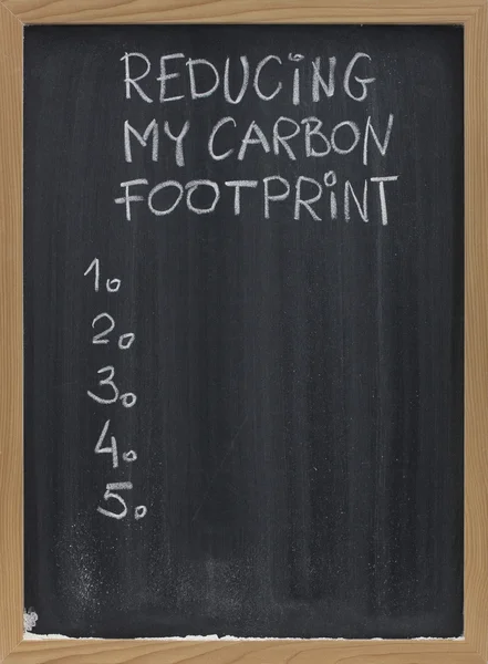 Reducing carbon footprint on blackboard — Stock Photo, Image