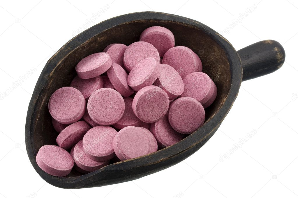 Scoop of pink pills (tablets)