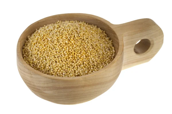 Scoop of hulled millet grain — Stock Photo, Image