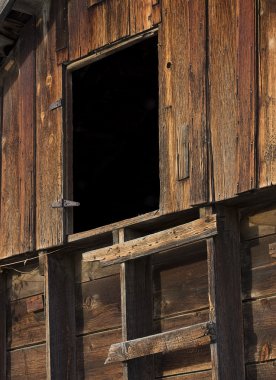 Primitive ladder and door in an old barn clipart