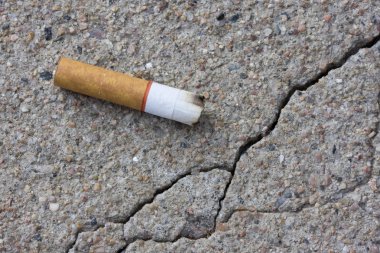 Cigarette butt on a sidewalk clipart