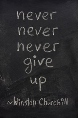 Never give up phrase on blackboard clipart