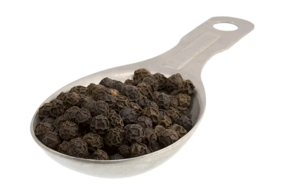 Tablespoon of black peppercorns — Stock Photo, Image