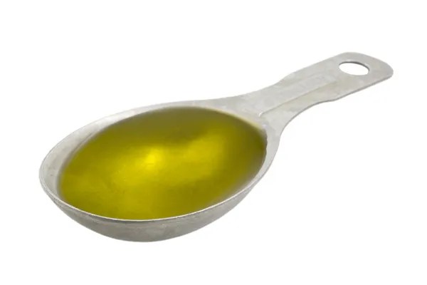Measuring tablespoon of olive oil — Stock Photo, Image