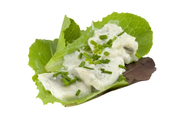 Herring in creme on lettuce leaves — Stock Photo, Image
