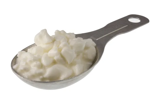 Measuring tablespoon of cottage cheese — Stock Photo, Image