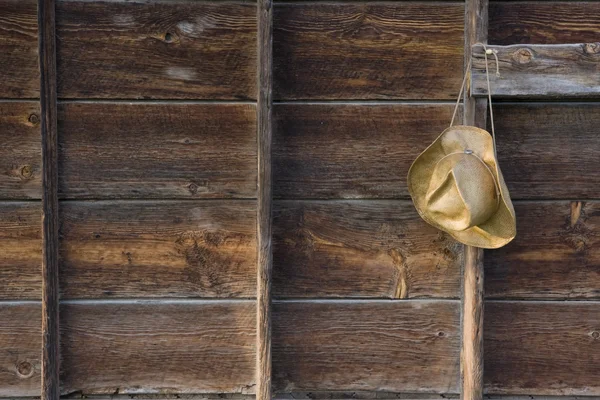 Słomkowy kowbojski kapelusz i wyblakły drewna — Zdjęcie stockowe
