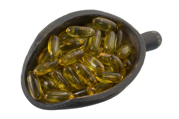 Scoop of fish oil capsules — Stock Photo, Image