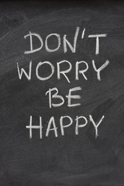 Don't worry be happy phrase on blackboard — Stock Photo, Image