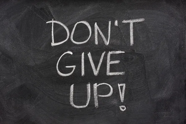stock image Dont give up phrase on blackboard
