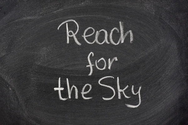 Reach for the sky phrase on blackboard — Stock Photo, Image
