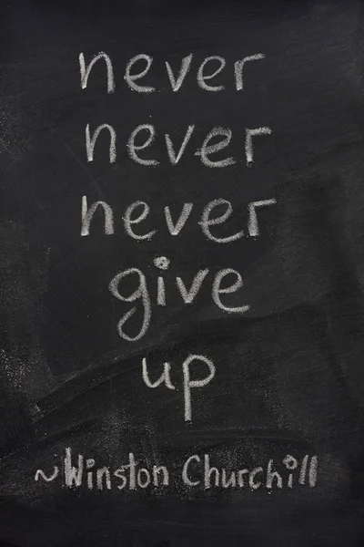Never give up phrase on blackboard — Stock Photo, Image