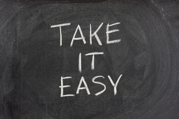 Take it easy phrase on blackboard — Stock Photo, Image