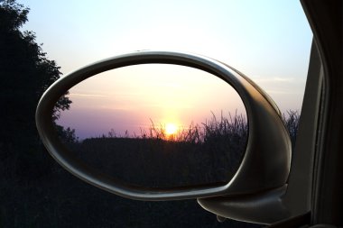 Sunset in the rearviewmirror clipart