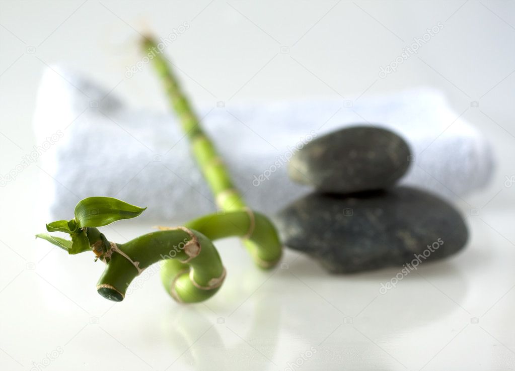 Bamboo branch with stones and towel