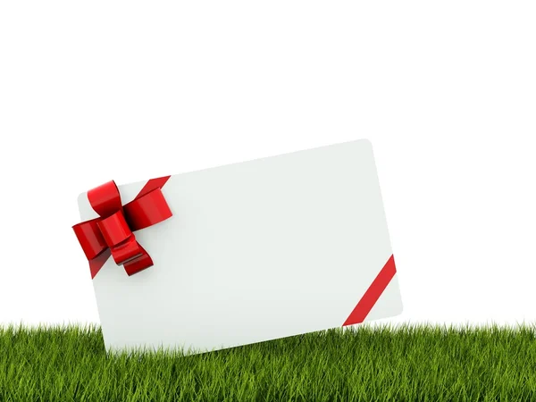 Kartkę z życzeniami z czerwoną kokardą na trawie — Zdjęcie stockowe