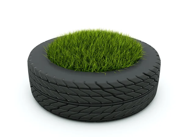 Tire with grass isolated on white — Stock Photo, Image