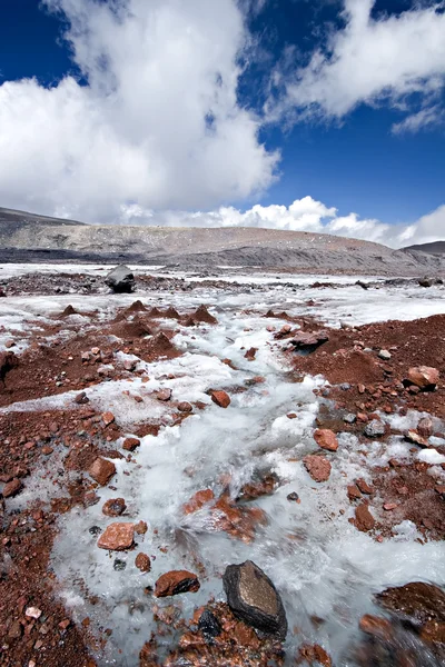 Glacier stream across stones in Caucasus — Stock Photo, Image