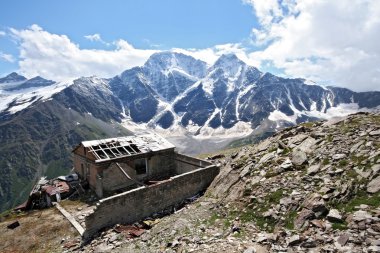 Old disturbed house in Caucasus mountain clipart