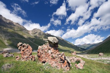 Rocks in mountain grass valley, Caucasus clipart