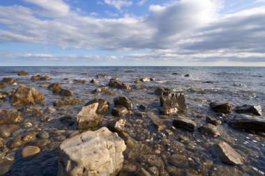 Sea coast, boulders, stones, clear water clipart