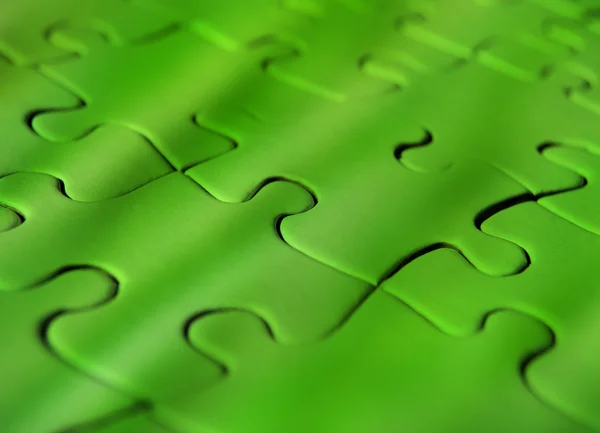 Green jigsaw puzzle — Zdjęcie stockowe