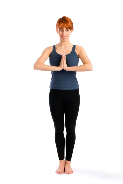 Atractiva mujer de pie en la postura de yoga —  Fotos de Stock