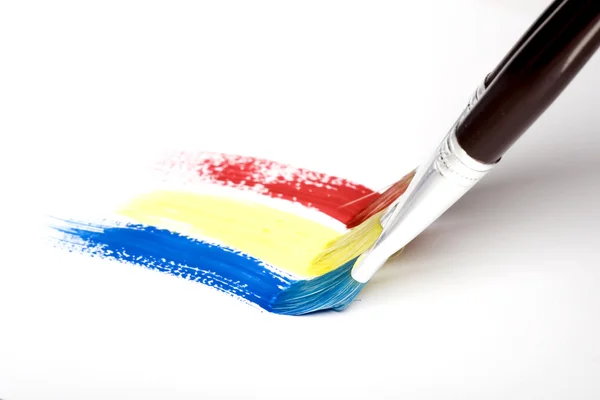 Paintbrush painting a rainbow stripe — Stock Photo, Image