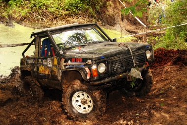 4x4 action through a huge mud hole. clipart