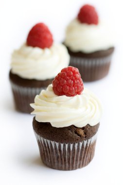 Chocolate and raspberry cupcakes clipart