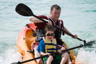 Father and son kayaking clipart