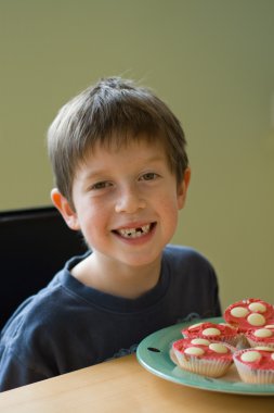 Boy with cupcakes clipart