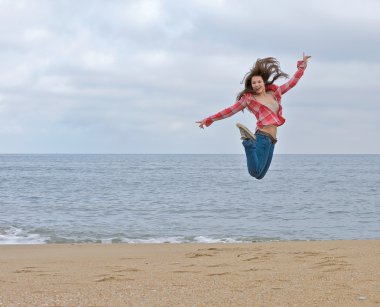 Teen girl jumping excitedly. clipart