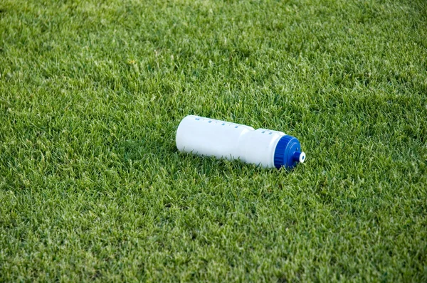 stock image Bottle of water on the green grass