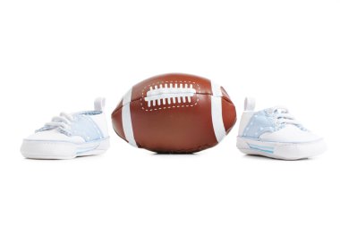 Football with baby shoes clipart