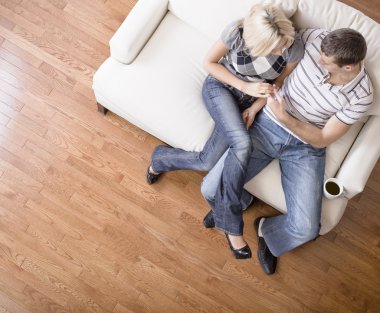 Young Couple Sitting on Love Seat clipart