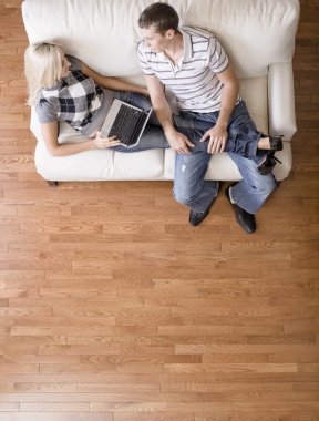 Overhead View of Couple Relaxing on Couch clipart