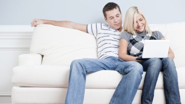 Happy Couple Relaxing on Couch clipart