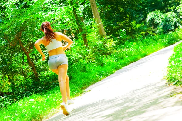 Mujer corredora en el bosque — Foto de Stock