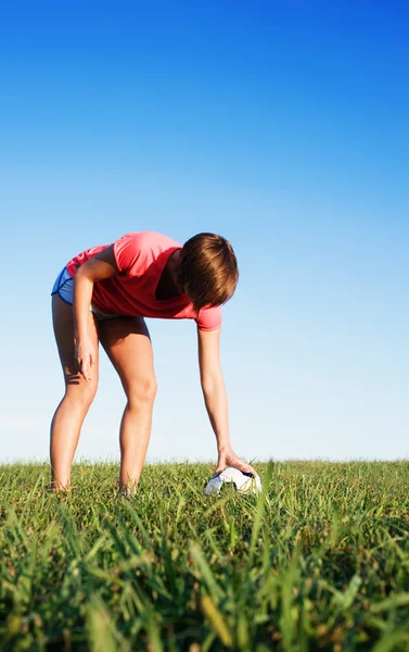 Mladá žena hrát fotbal — Stock fotografie