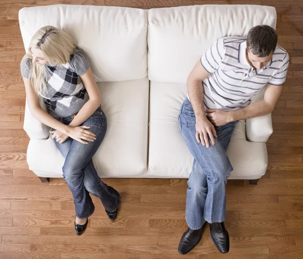 Young Couple Sitting on Love Seat — Stock Photo, Image