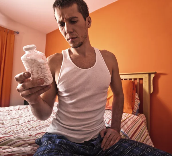 Man Looking at Bottle of Pills — Stock Photo, Image