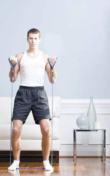 Man Using Resistance Bands in Living Room — Stock Photo, Image