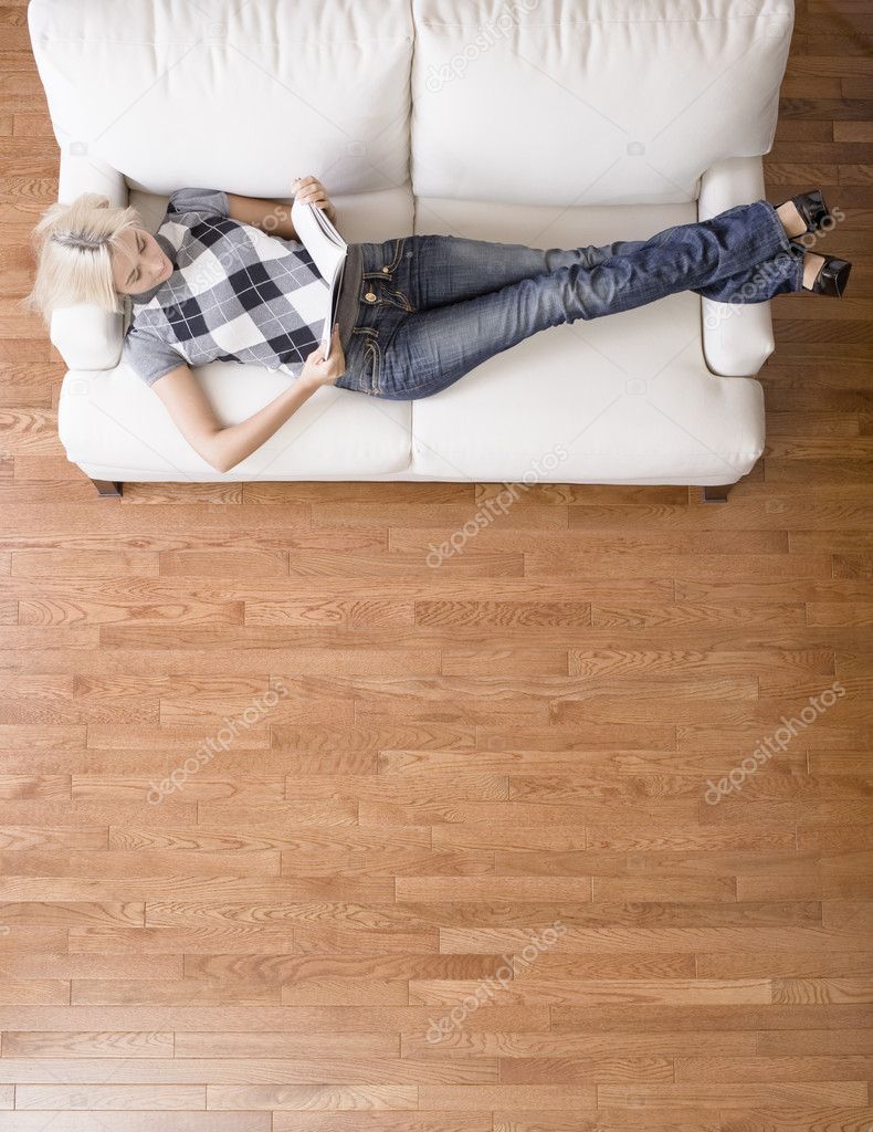 Overhead View of Woman Reading on Couch