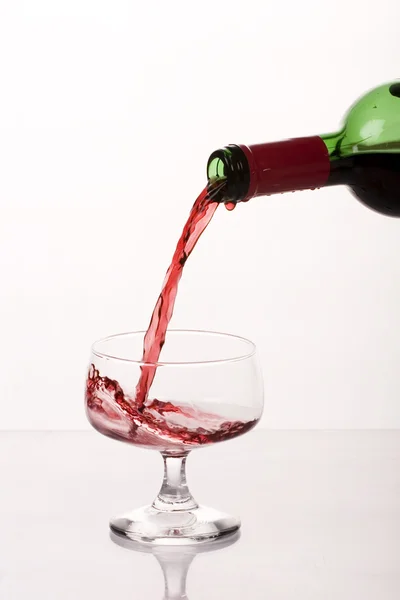 stock image Red wine pouring into wine glass