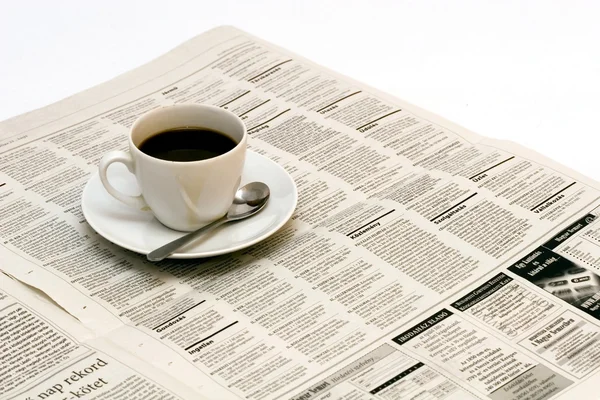 stock image Cup with coffee on newspaper