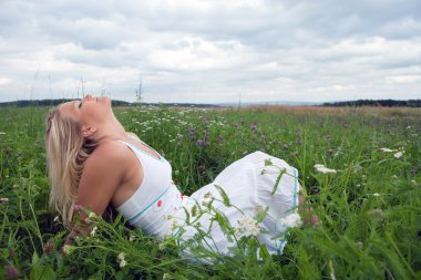 Young woman on a meadow clipart