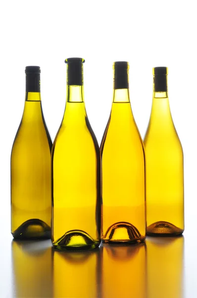 Quatro garrafas de vinho volta Lit — Fotografia de Stock