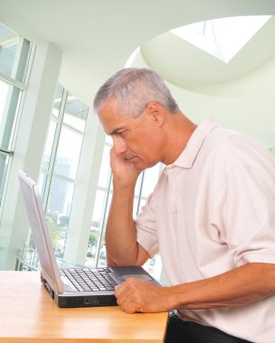 Man Looking Intently at Laptop clipart